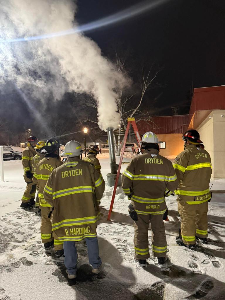 Dryden Firefighters around a chimney fire simulation